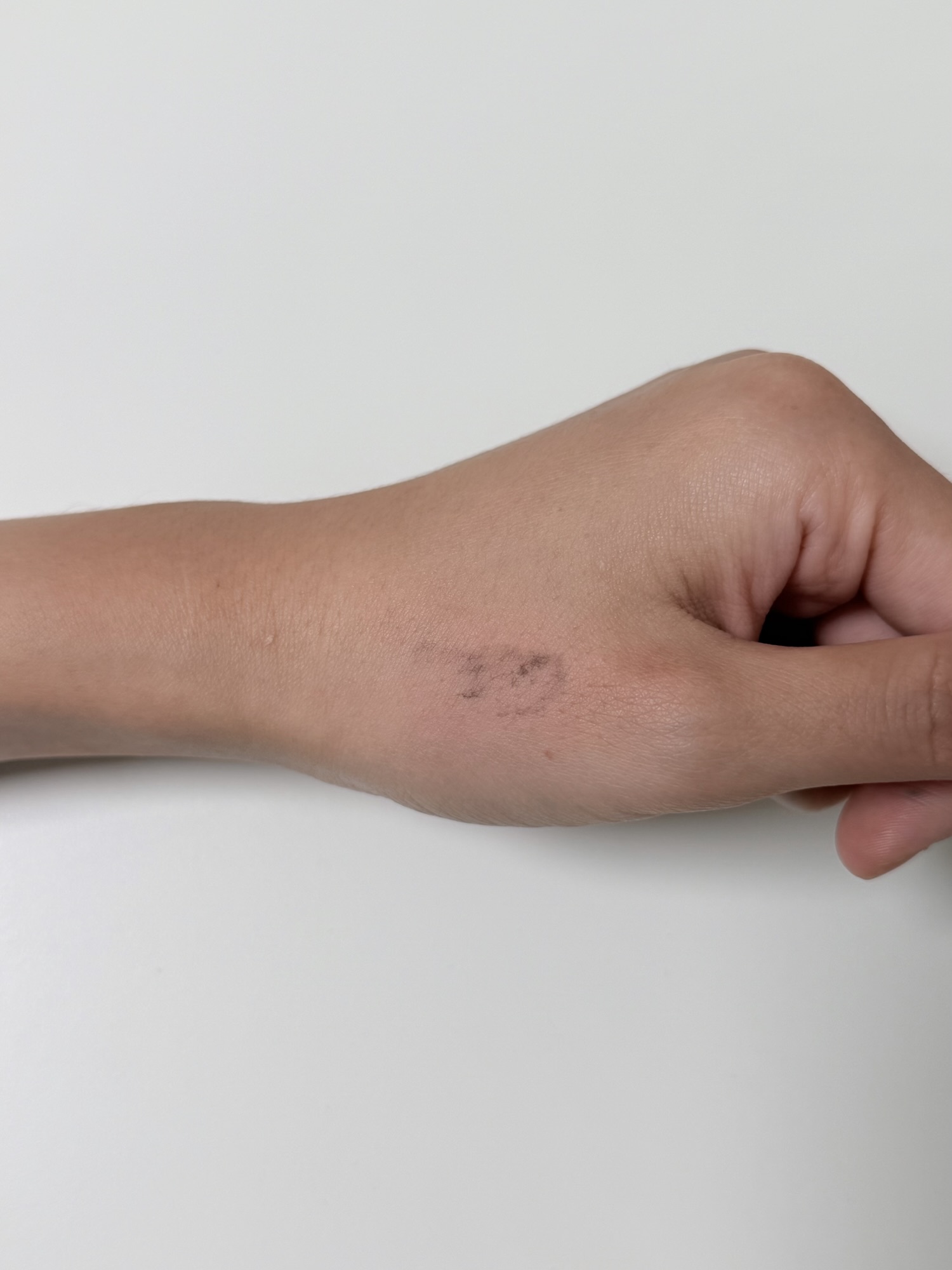 Back of hand after cleansing test with mascara residue left behind