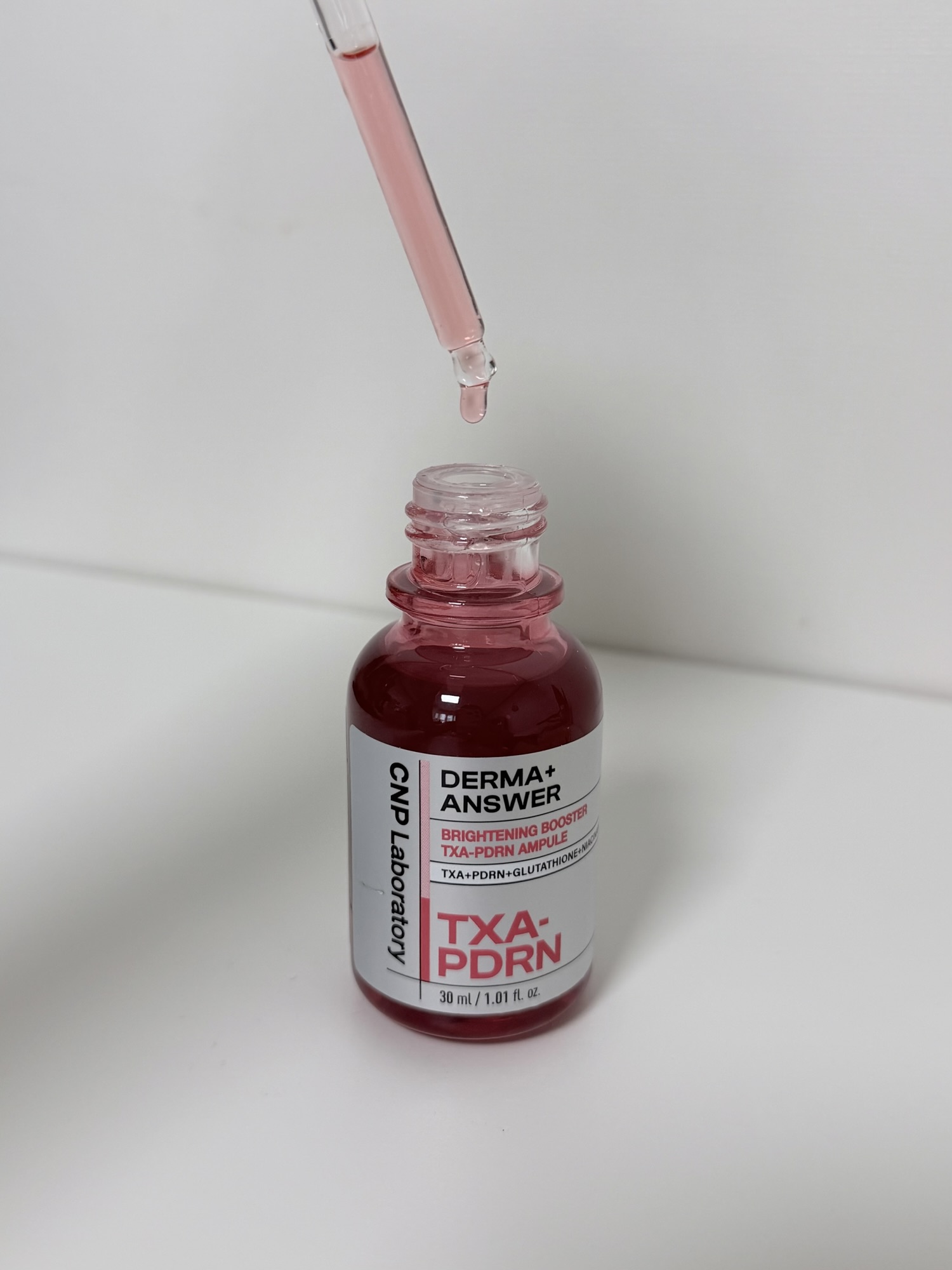 CNP TXA-PDRN Ampule dropper showing pink serum texture