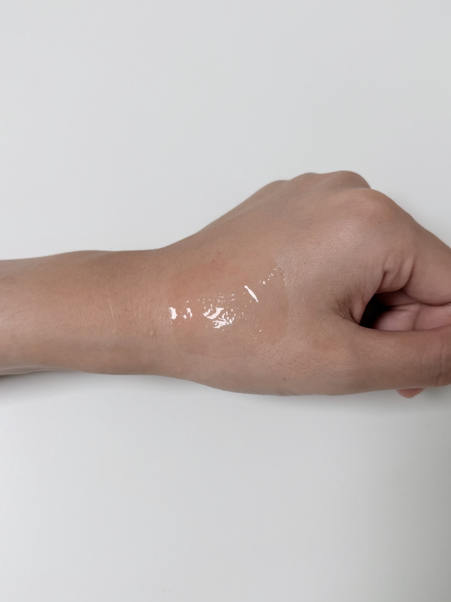 CNP TXA-PDRN Ampule spread across the back of a hand