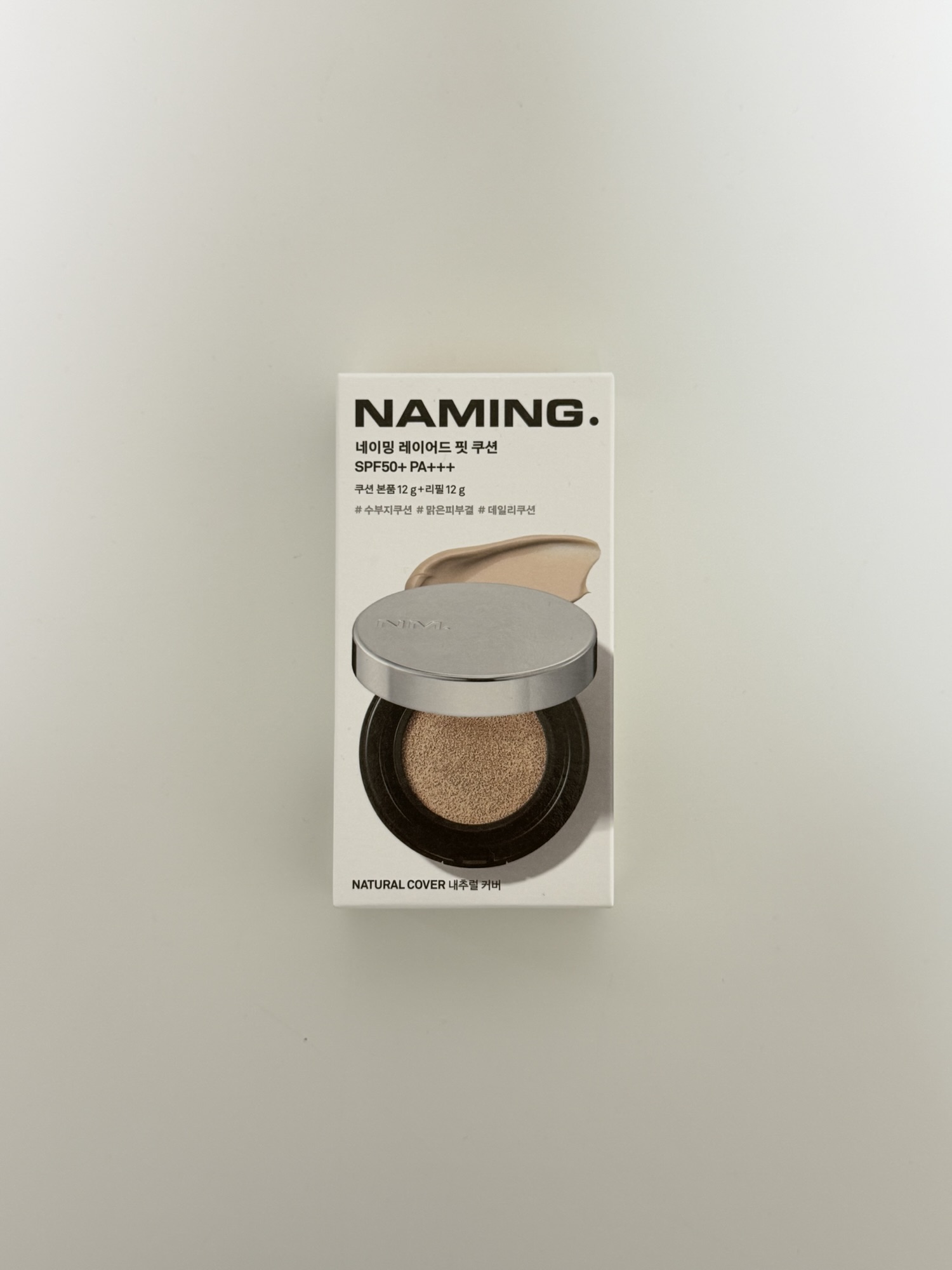 NAMING Layered Fit Cushion package showing SPF50 PA+++ and natural cover finish