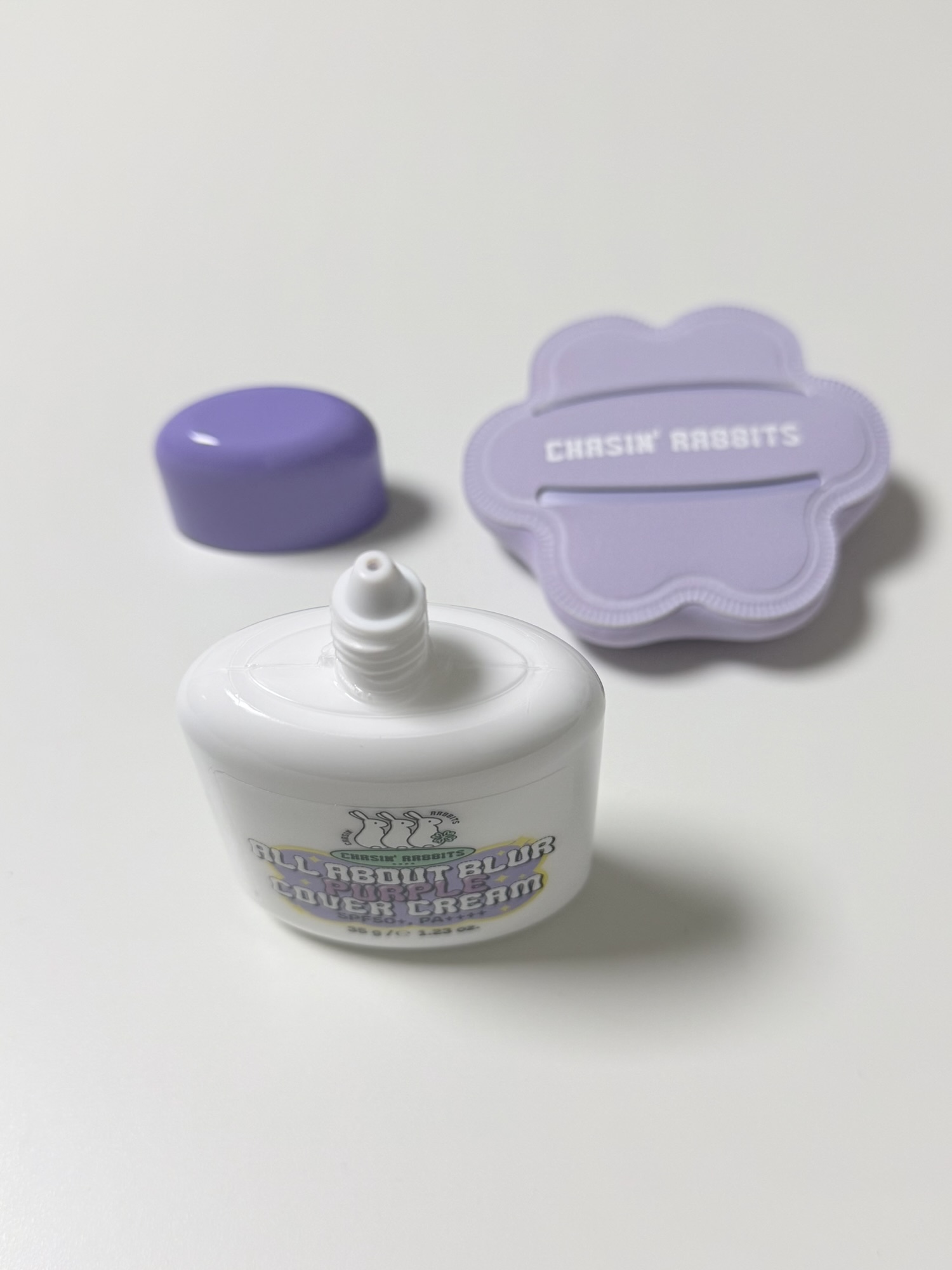 Open Chasin' Rabbits Purple Cover Cream bottle with a narrow nozzle for controlled dispensing