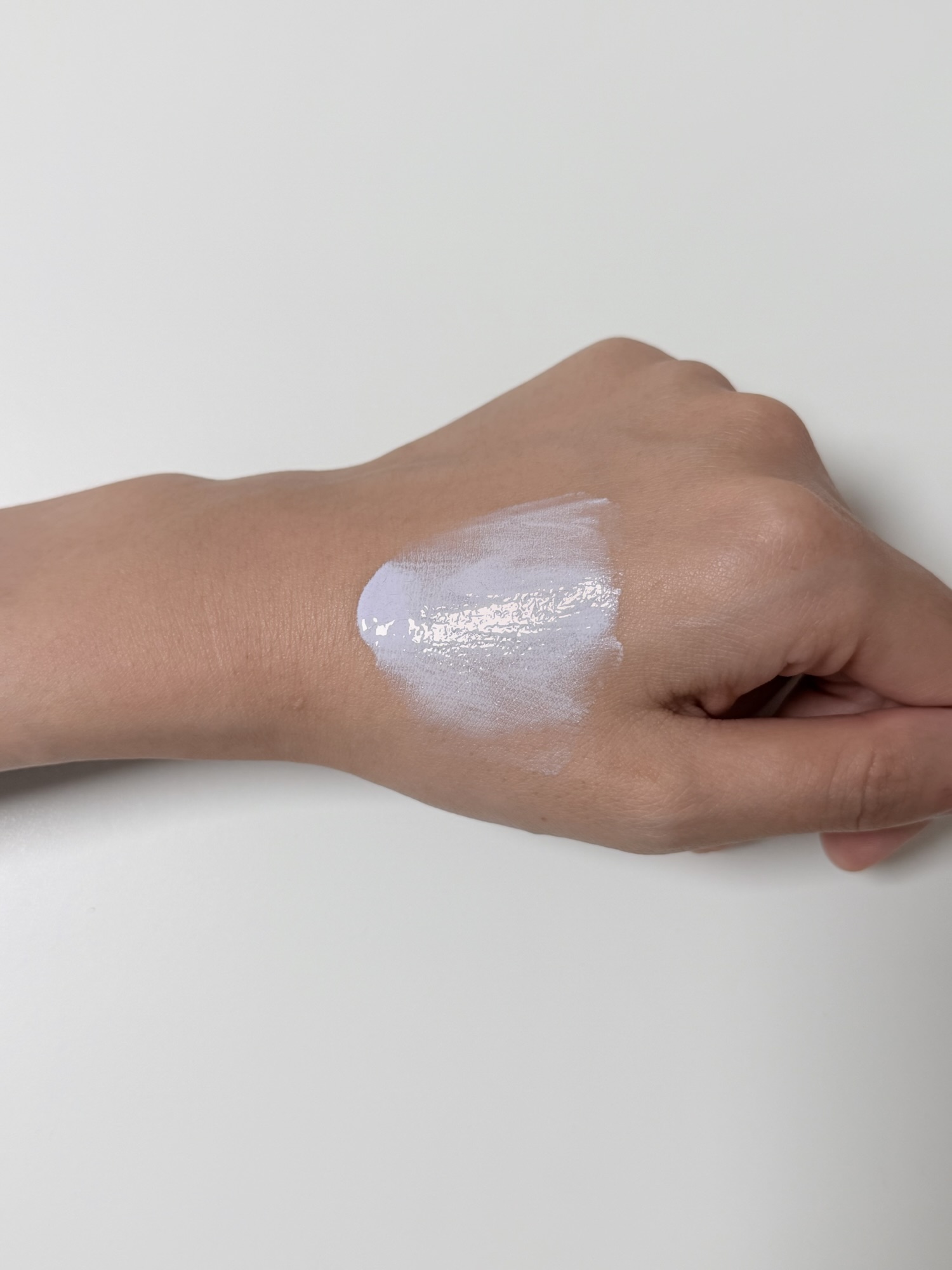 Chasin' Rabbits Purple Cover Cream spread across the back of a hand during blending
