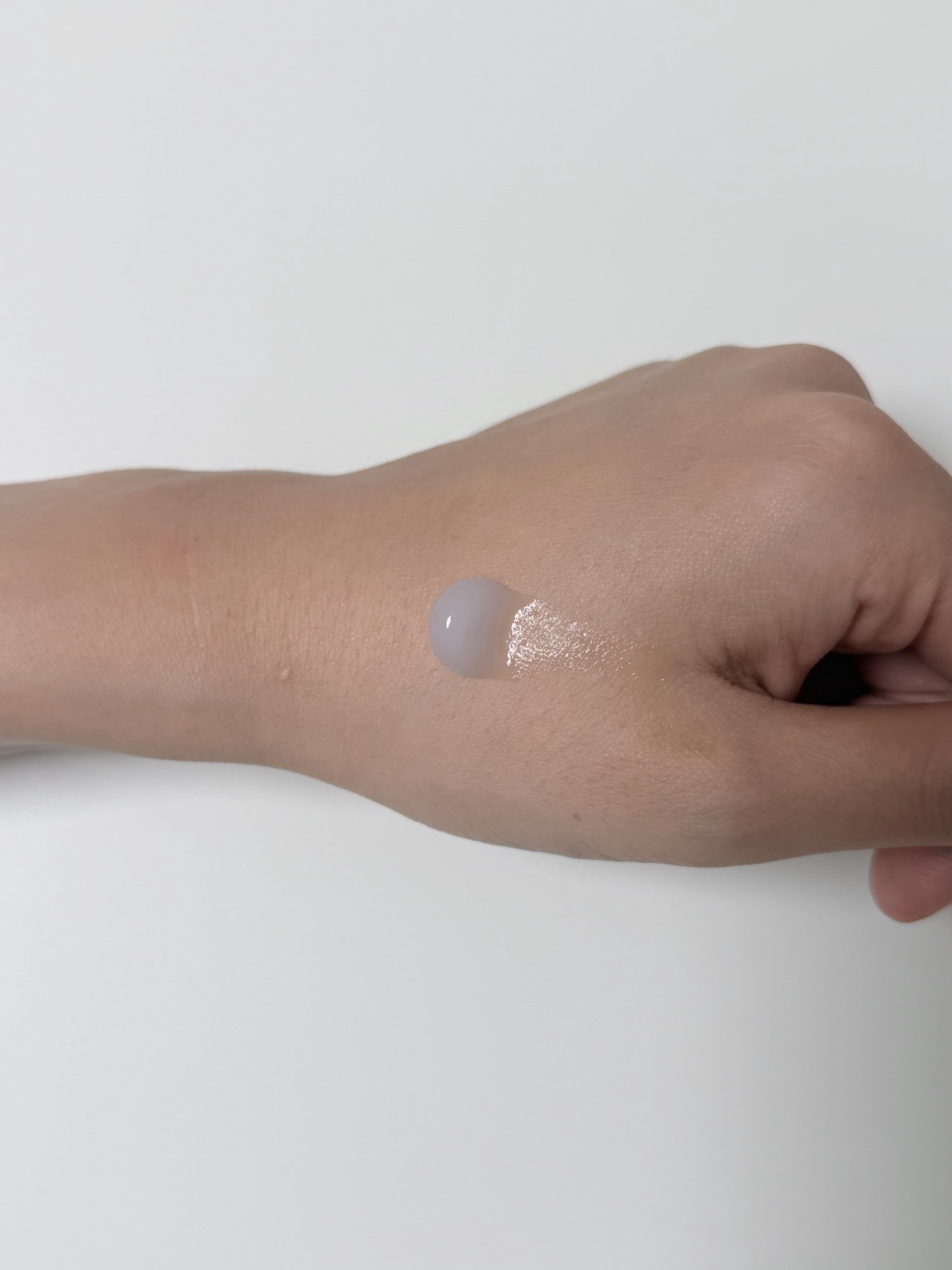 Pale purple Isntree Onion Newpair gel cream on the back of a hand